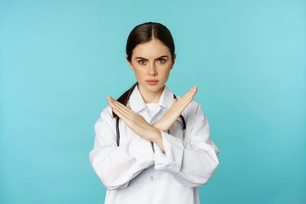 An aesthetic surgeon doing an x pose