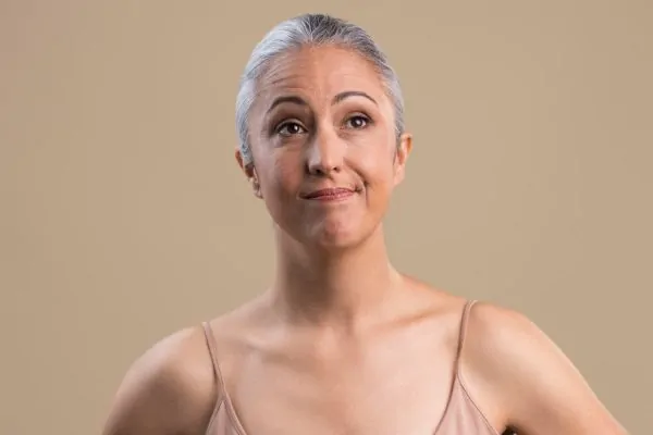 Old woman enjoying her face after having her jowls removed