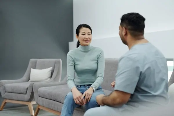 Plastic surgeon giving post recovery tips to a patient after liposuction procedure