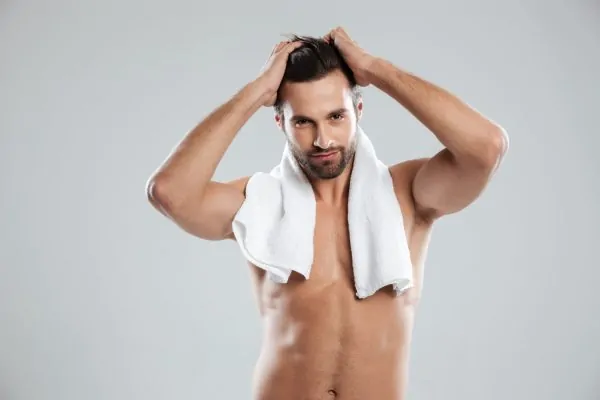 Young man posing with towel after PDO thread lift
