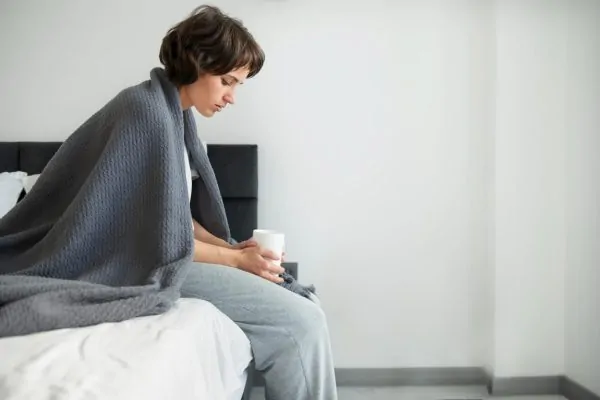 A woman recovering from tummy tuck surgery