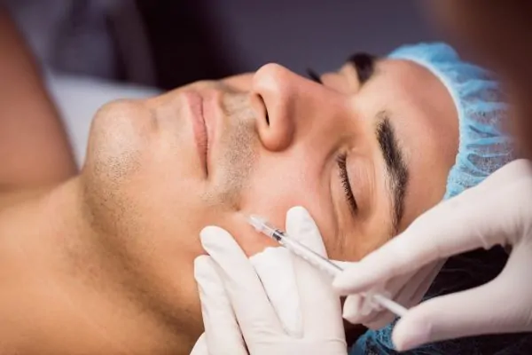 Man receiving botox injection for Smile Lines