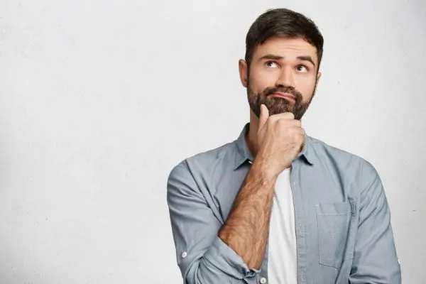 A concerned man thoughtfully considering the different types of reconstructive surgery procedures available to him