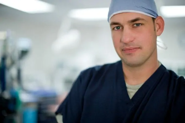 A cosmetic surgeon preparing for a plastic surgery procedure