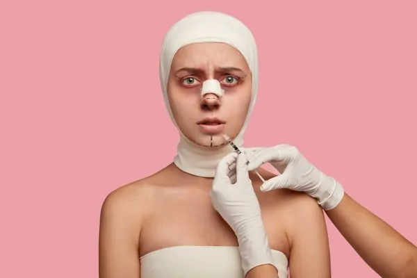 A lady who is in a bandage after having plastic surgery