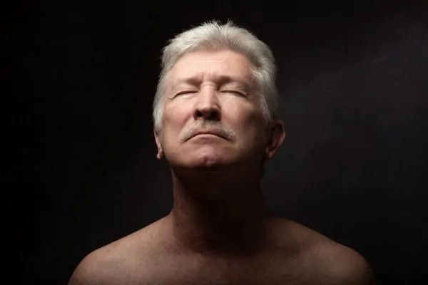 A mature man with eyes closed and a calm, relaxed expression, reflecting on how long Botox results last for forehead wrinkles.