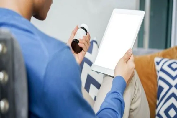 A plastic surgery patient is reading instructions for their medications