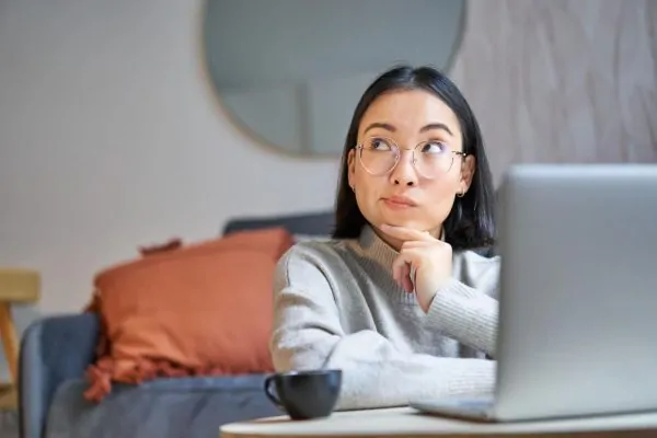 Beautiful asian girl works from home studying with laptop (1)