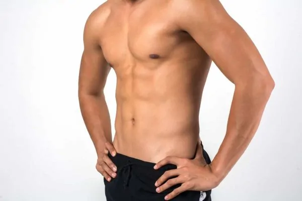 Close-up of a man's lean, contoured midsection and abdomen, illustrating the smooth, sculpted results typically achieved through laser liposuction procedures