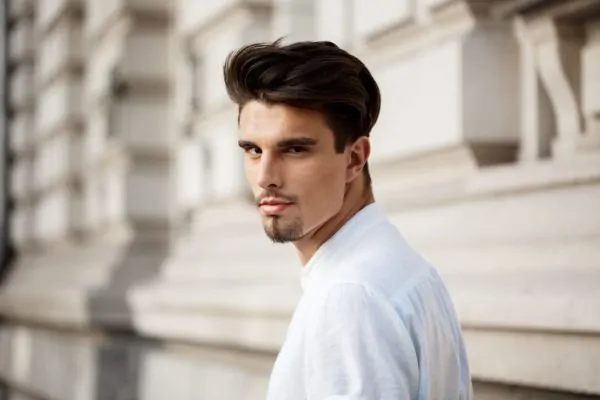 Confident man with styled hair and defined facial features outdoors, representing the aesthetic investment of PDO thread lift treatments for men