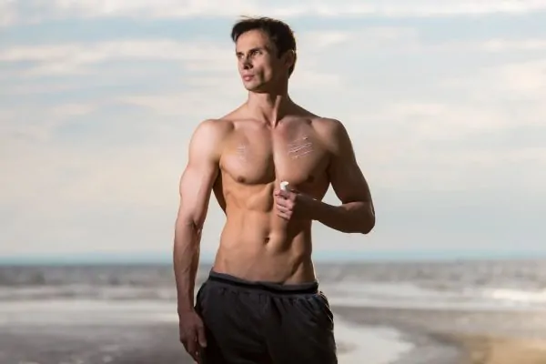 Fit man showcasing a toned and contoured body after liposuction results