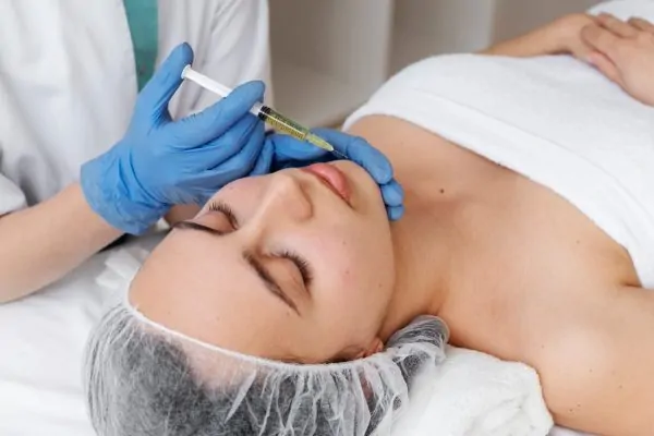 High angle woman getting face treatment