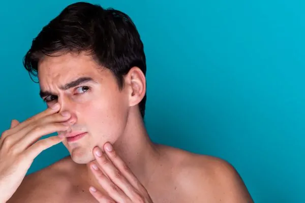Man evaluating facial contours for FaceTite radiofrequency procedure