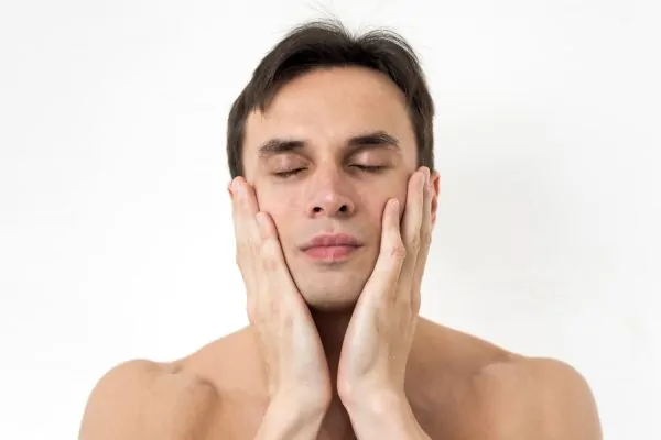 Man evaluating jawline structure for dermal filler treatment