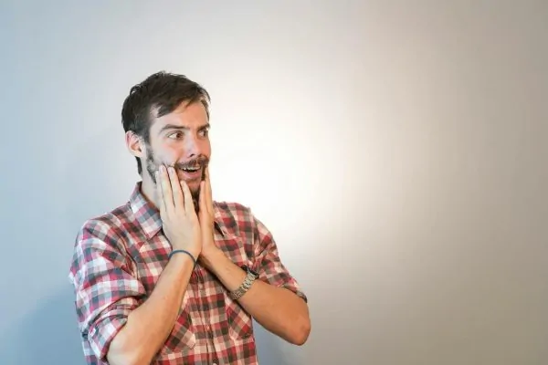 Man holding his cheeks