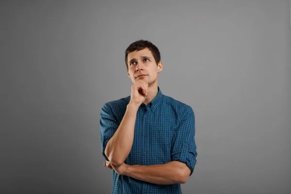 Man in a thoughtful pose considering how skin tightening can dramatically improve his liposuction results