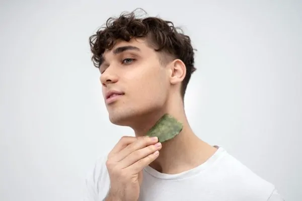 Man performing neck skincare routine before Accent Prime treatment