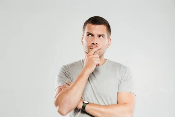 Man thinking about the key differences between high-definition liposuction and traditional liposuction