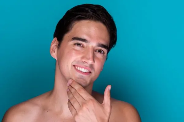 Man touching firm jawline showing results of non-surgical PDO thread lift for jowls