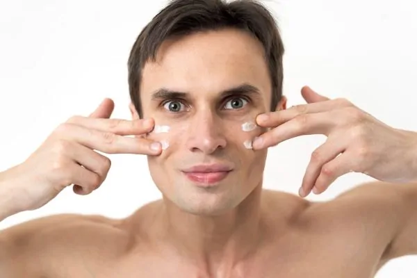 Man with facial cream considering FaceTite treatment and choosing experienced specialist