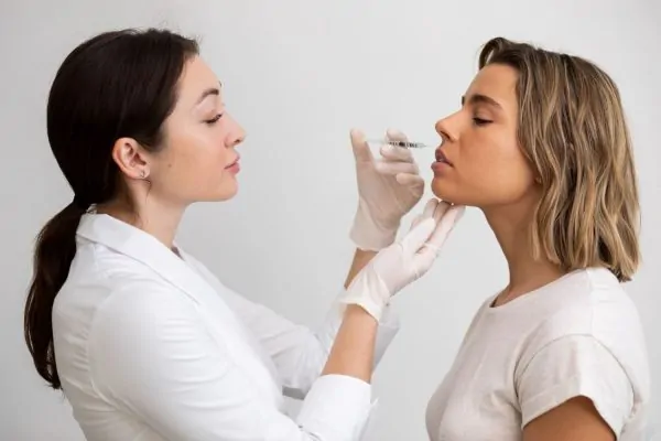 Medical professional discussing different jawline filler types and options with patient