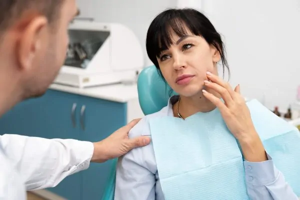 Patient consulting with doctor about jawline filler maintenance appointment schedule