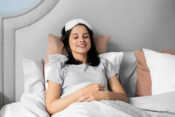 Patient in proper elevated sleeping position for tummy tuck recovery with upper body raised