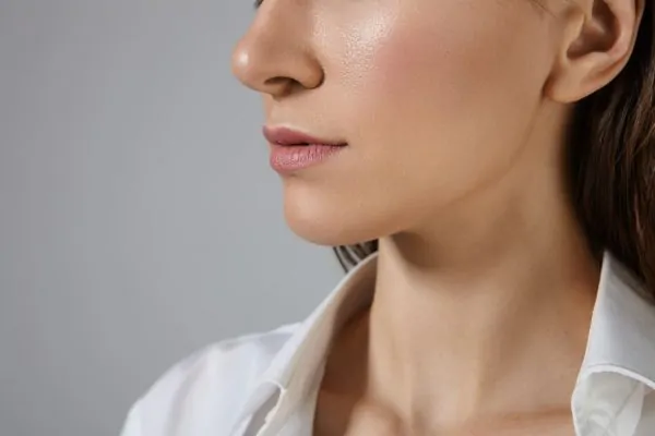 Side profile of woman's defined jawline and chin, showcasing potential results of jawline filler treatment