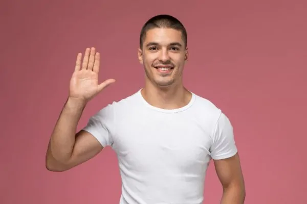 Smiling young man with healthy, youthful skin demonstrating results from non-invasive cosmetic treatments