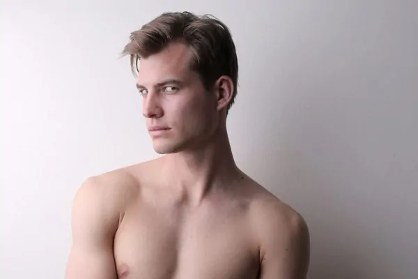 Young man displaying defined facial contours achievable through FaceTite versus other procedures