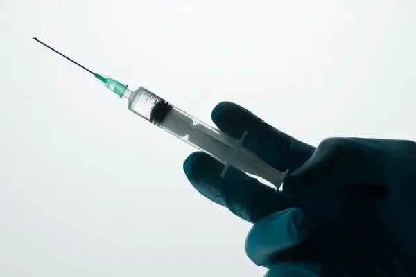 Doctor holding a syringe in hand