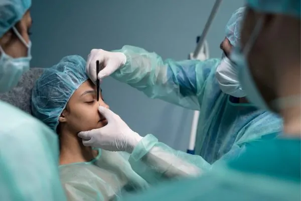 doctor checking patient before rhinoplasty