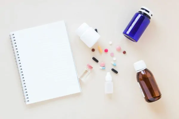 Flat lay medical composition with notepad