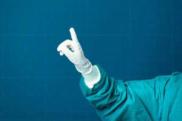Hand in medical glove of plastic surgeon
