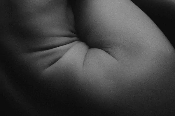 Person's side view of loose skin