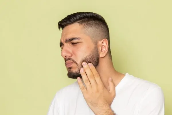male in Pain from Jawline Filler
