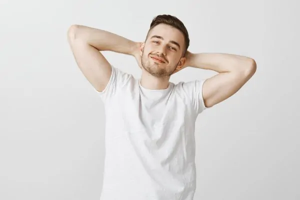 man holding hands behind head