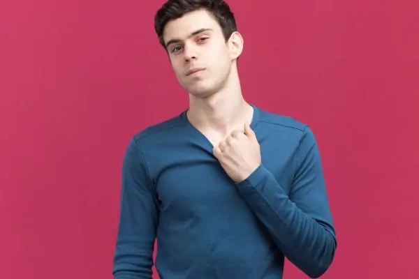 man pulling collar showing his neck