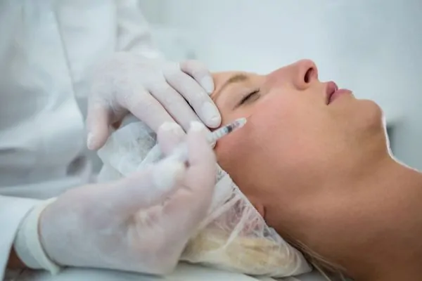 patient receiving a botox injection on face