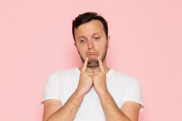sad man in white t-shirt with bad jawline