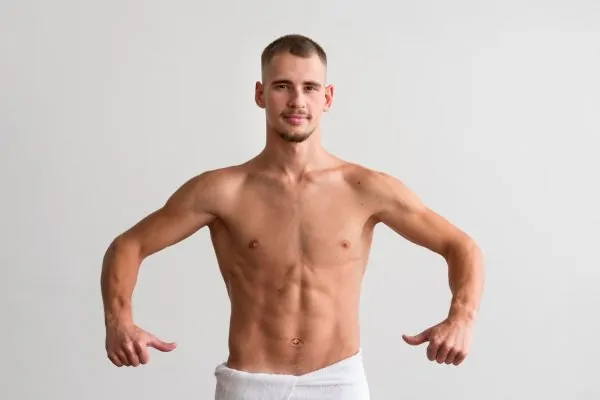 Shirtless man showing off his Tummy Tuck result