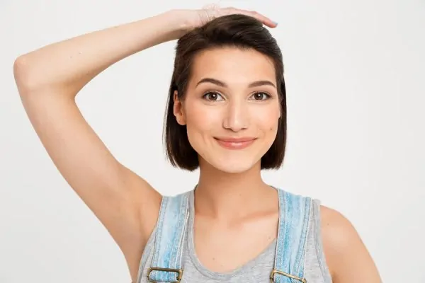 smiling woman showing her armpits