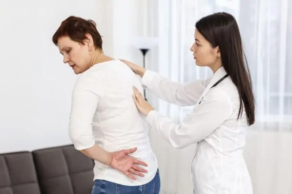 surgeon touching a patients back