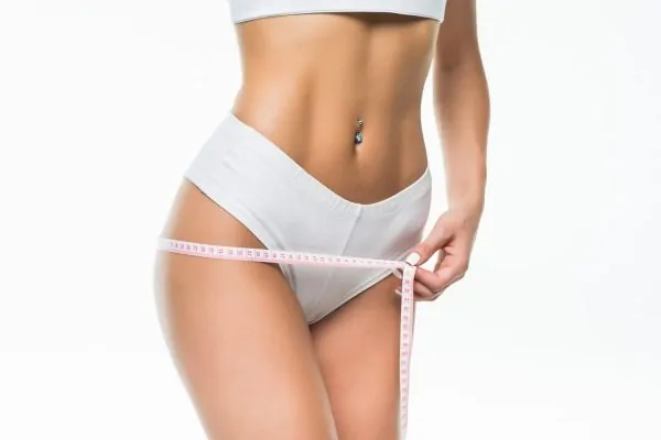 woman body with yellow measure tummy post liposuction