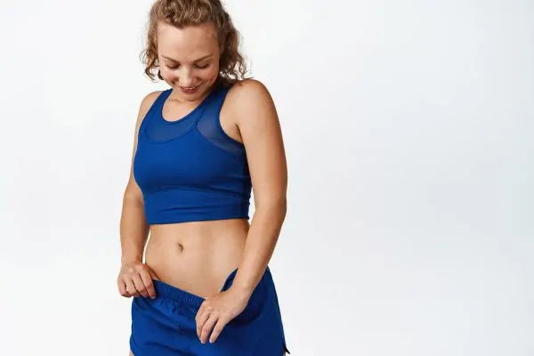 woman showing her tummy tuck result