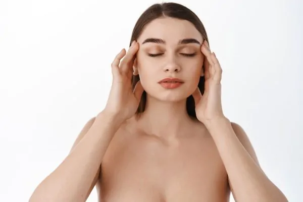Woman touching her face