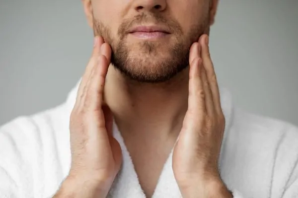 Young man applying his anti aging treatment